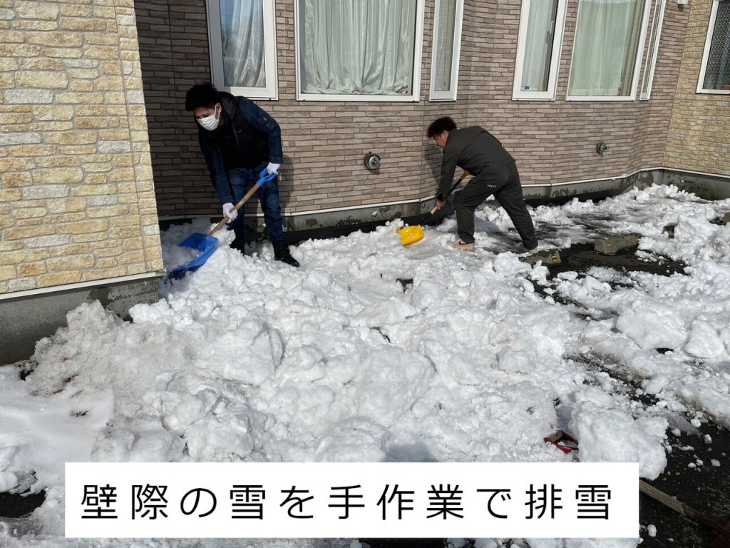 壁際の雪を手作業で排雪